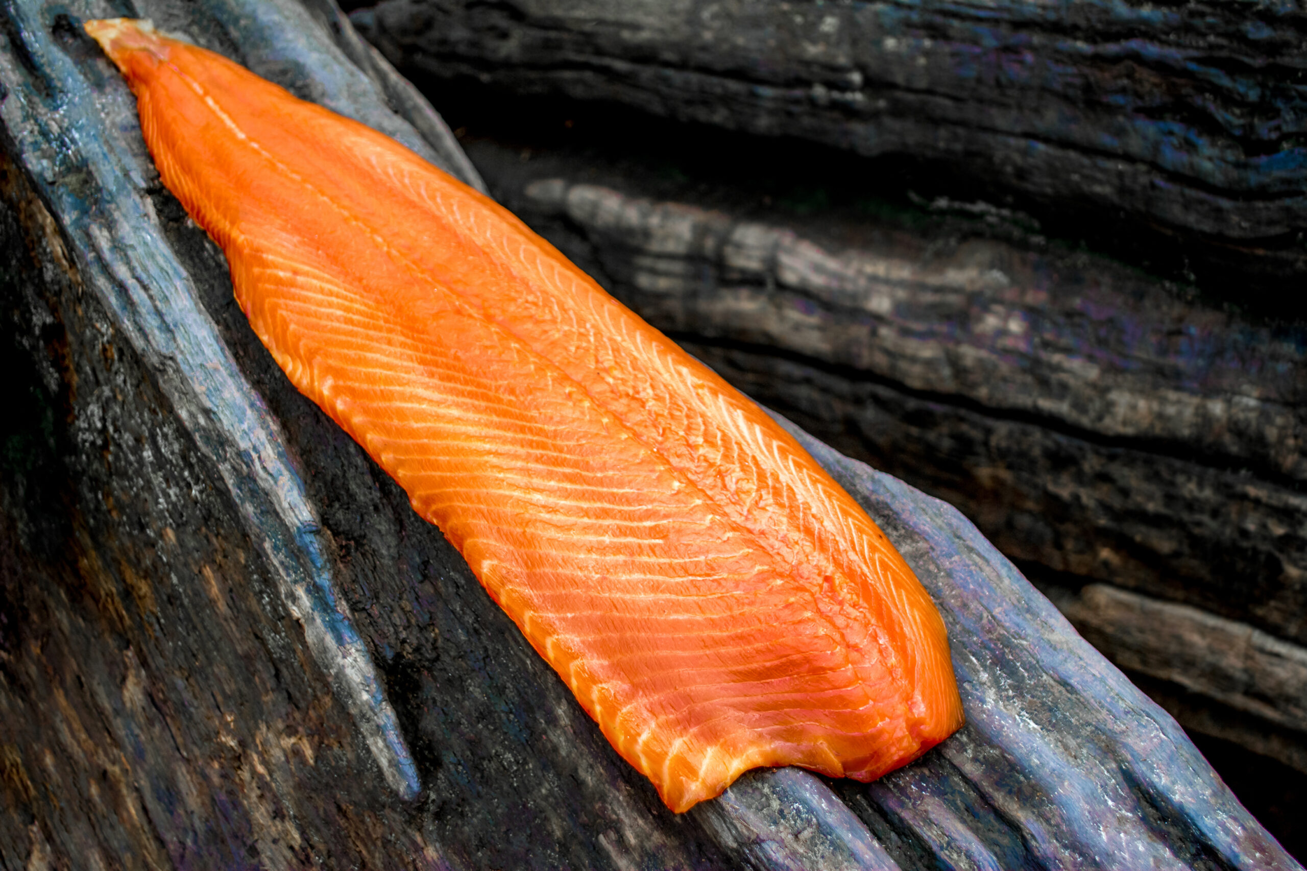 Close-up,Of,Smoked,Salmon,Side,On,An,Old,Sloped,Tree